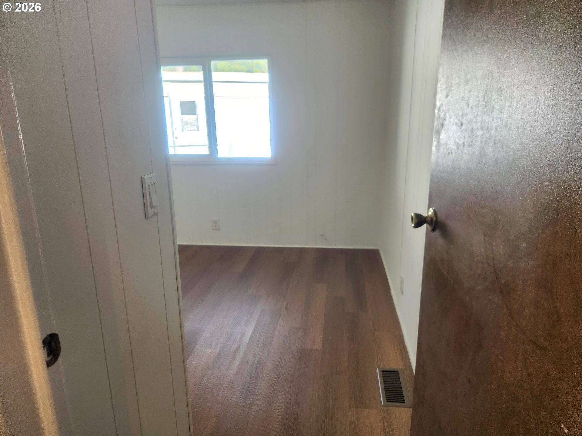 507 North 19th Avenue, Unit 29 Cornelius, OR 97113 - Photo 23 of 26 an empty room with wooden floor and a window