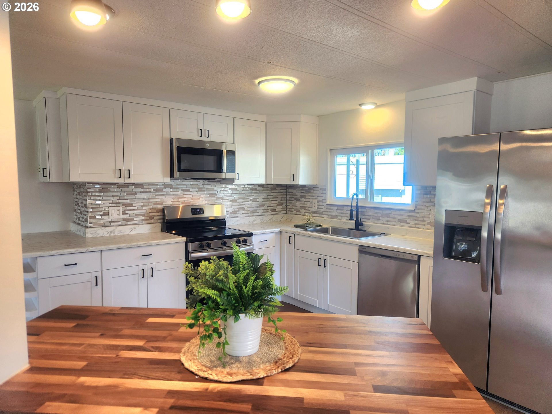 507 North 19th Avenue, Unit 29 Cornelius, OR 97113 - Photo 6 of 26 a kitchen with a stove a sink and a refrigerator