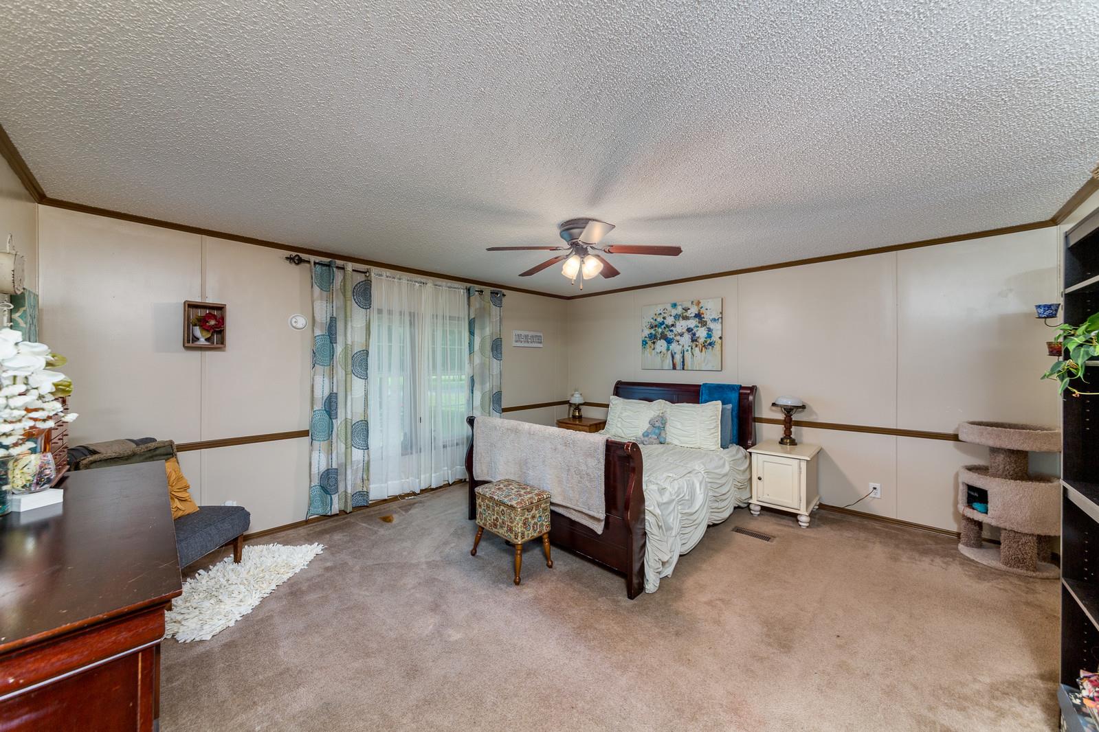 6345 Roy Pearson Road Springfield, TN 37172 - Photo 13 of 30 a bed room with a bed and a night stand