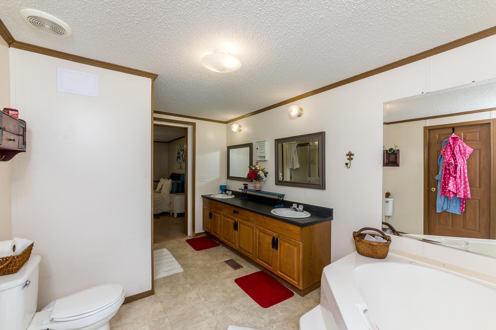6345 Roy Pearson Road Springfield, TN 37172 - Photo 16 of 30 a bedroom with a bed and a flat screen tv