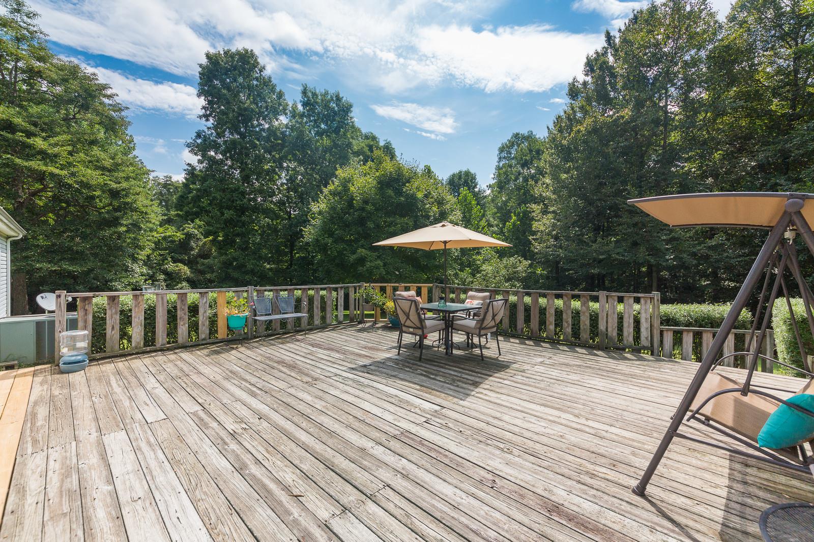6345 Roy Pearson Road Springfield, TN 37172 - Photo 25 of 30 a balcony with wooden floor and outdoor seating