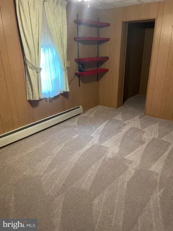 an empty room with a window and wooden floor