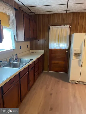 a kitchen with a sink and a refrigerator