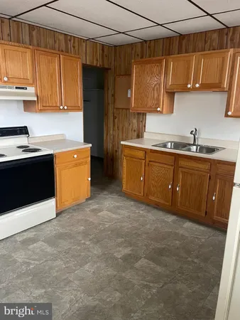 a kitchen with stainless steel appliances granite countertop a sink and cabinets