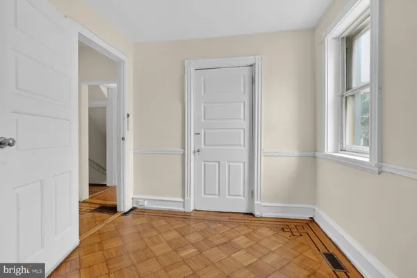 a view of a room with wooden floor and a window
