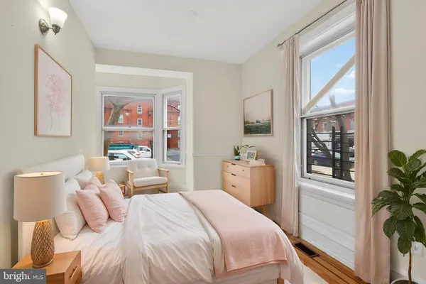 a bedroom with a bed and a large mirror