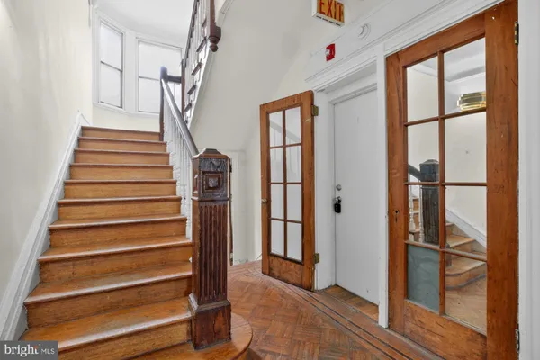 a view of entryway with wooden floor and stairs