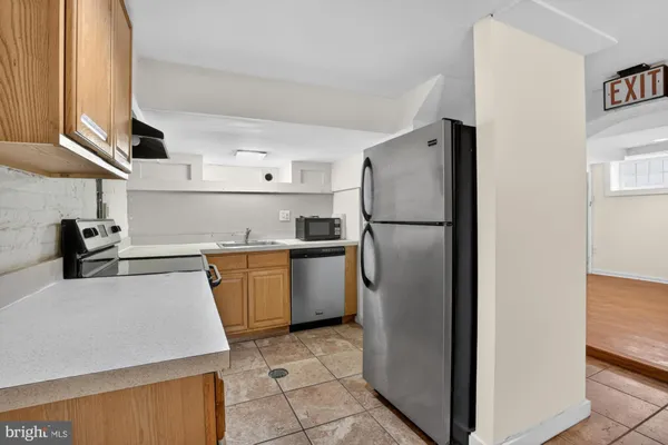 a kitchen with a refrigerator sink and cabinets