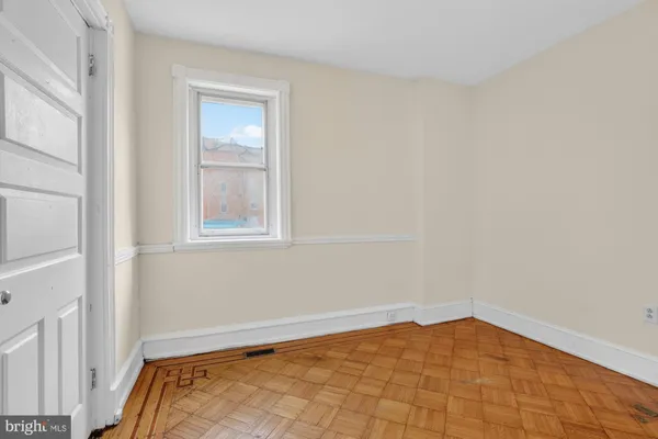 a view of a room with a white walls and a window
