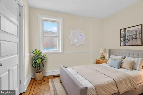 a bedroom with a bed and a window