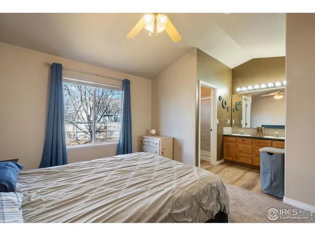 a bedroom with a bed and a view of kitchen