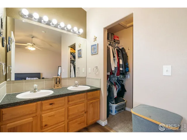 a bathroom with a double vanity sink and a mirror
