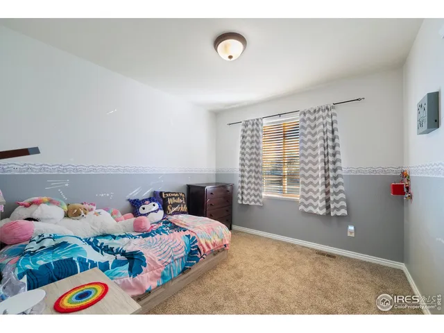 a bedroom with a bed and a window in it