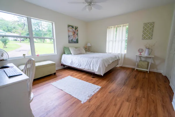 a spacious bedroom with a bed and a couch