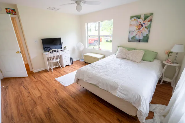 a bedroom with a bed and a flat screen tv