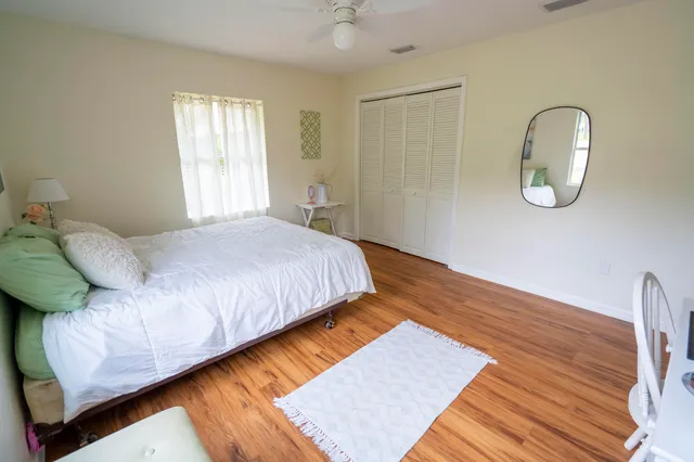 a bedroom with a bed lamp and a window