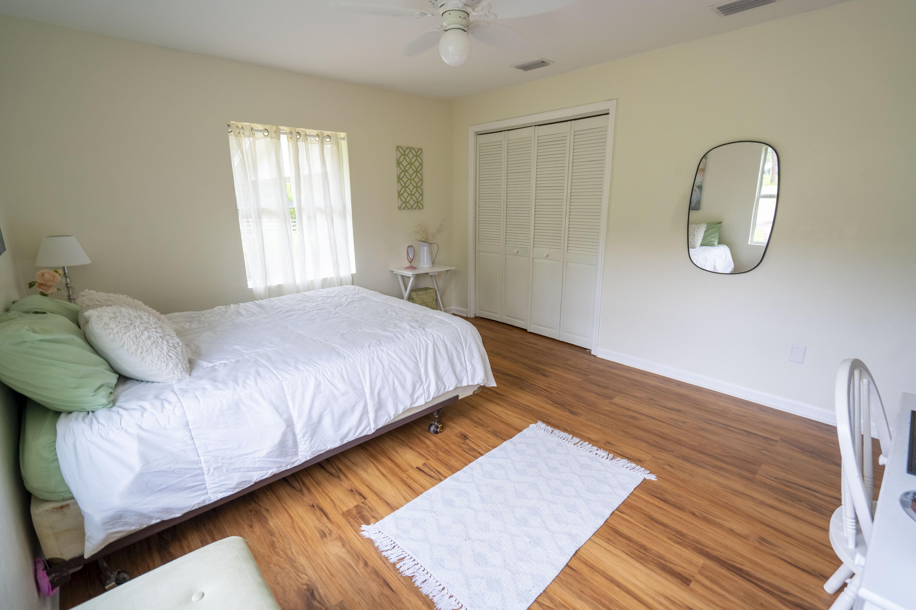 6611 Crooked Creek Road Tallahassee, FL 32311 - Photo 19 of 50 a bedroom with a bed lamp and a window