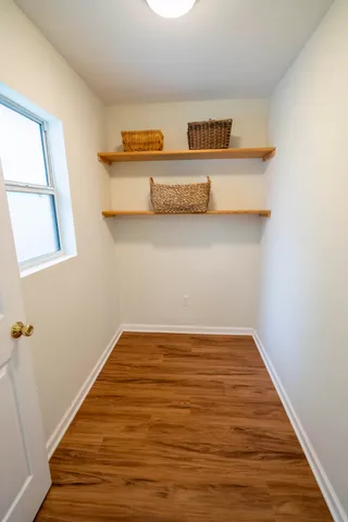 a view of kitchen cabinets and wooden floor