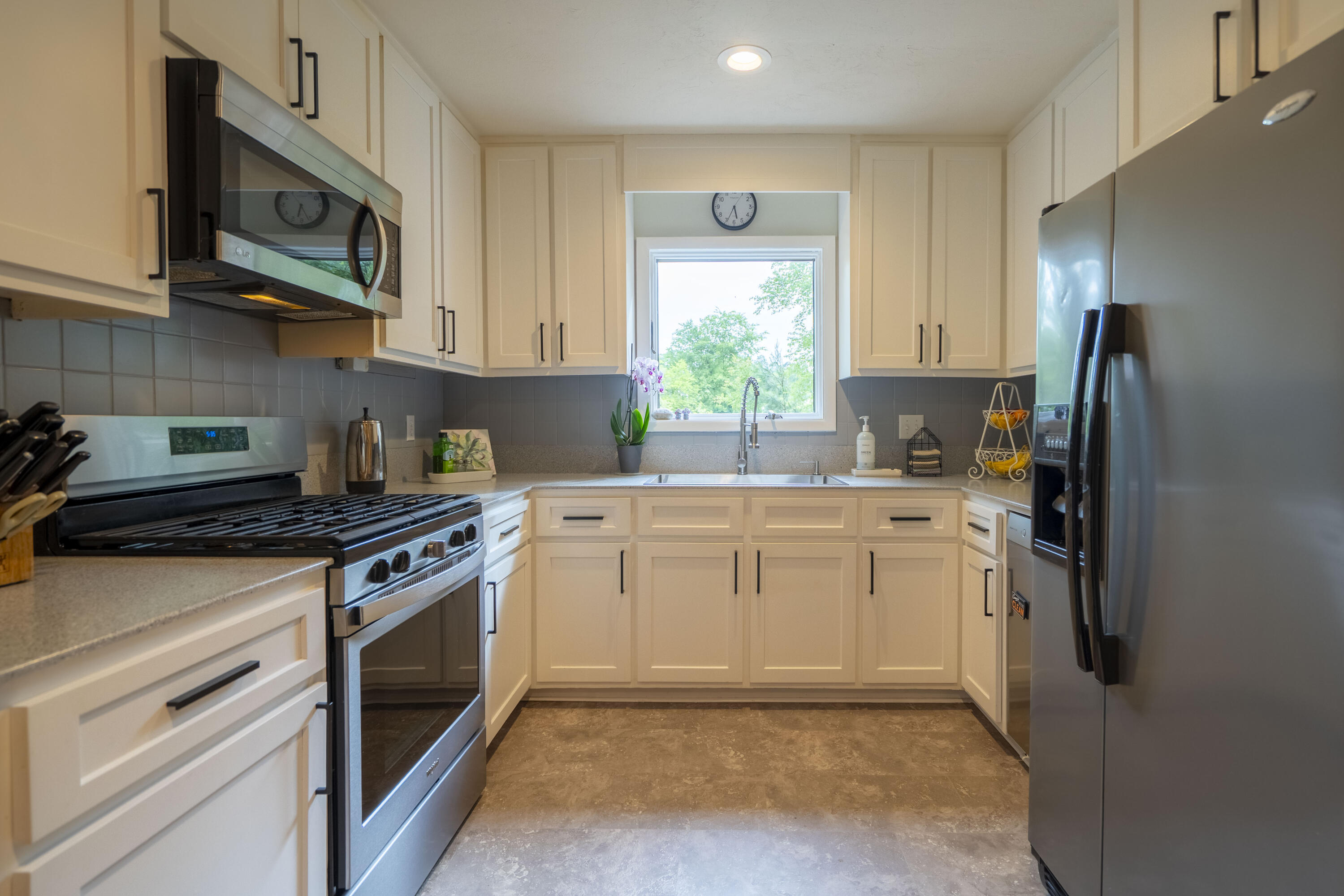 6611 Crooked Creek Road Tallahassee, FL 32311 - Photo 23 of 50 a kitchen with stainless steel appliances granite countertop a stove a refrigerator and a microwave