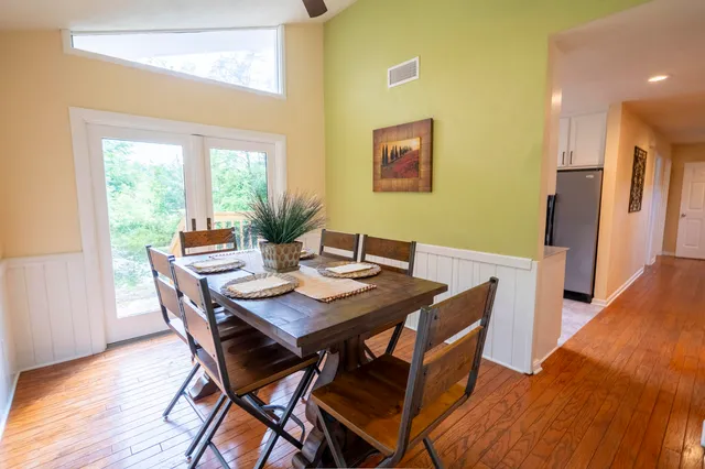 a view of a dining room with furniture and wooden floor