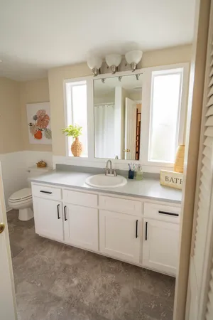 a bathroom with a double vanity sink a mirror and a bathtub