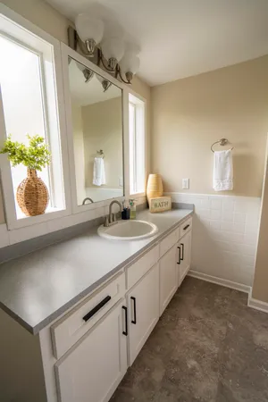 a bathroom with a sink and a window
