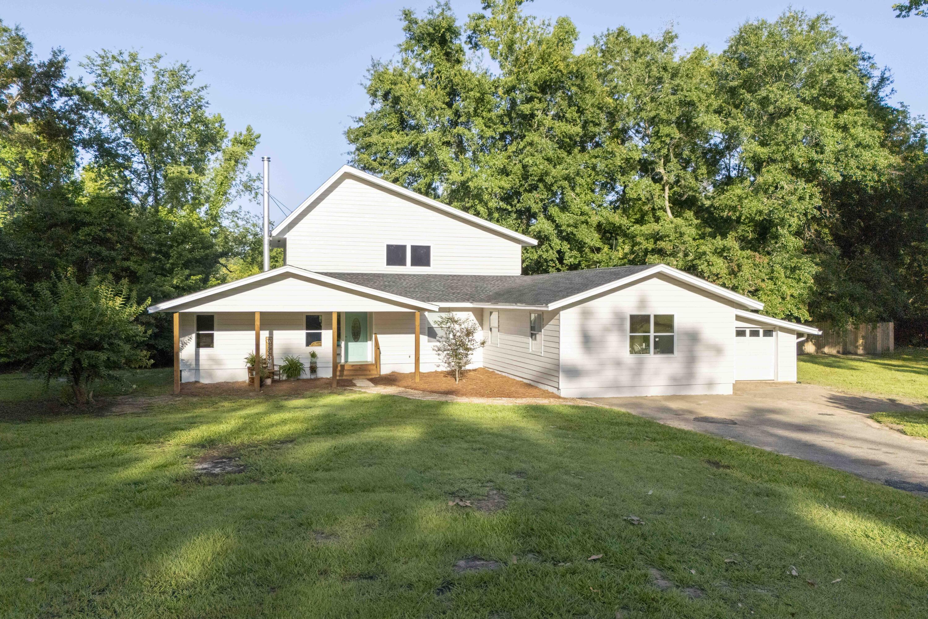6611 Crooked Creek Road Tallahassee, FL 32311 - Photo 3 of 50 a front view of a house with a yard and trees