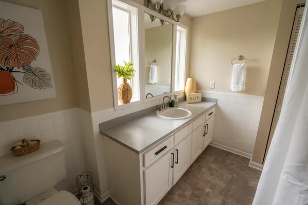 a bathroom with a double vanity sink and a mirror