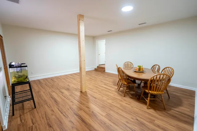 a view of a dining room with furniture and wooden floor