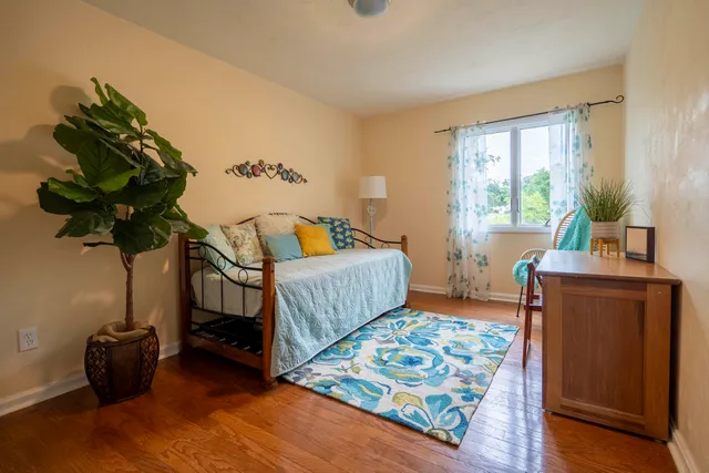 a bedroom with furniture and a window