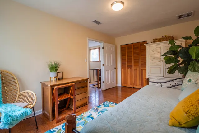 a bedroom with furniture and a potted plant