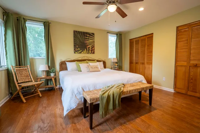 a bedroom with a bed and wooden floor