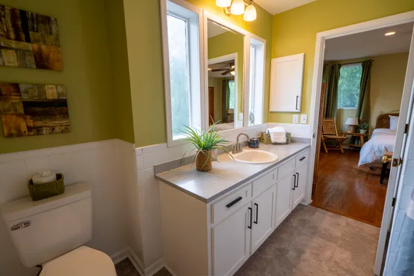 a bathroom with a sink a toilet and a mirror