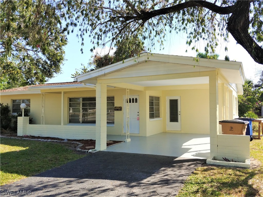 112 Clayton Avenue Lehigh Acres, FL 33936 - Photo 1 of 16 a view of a house with a patio