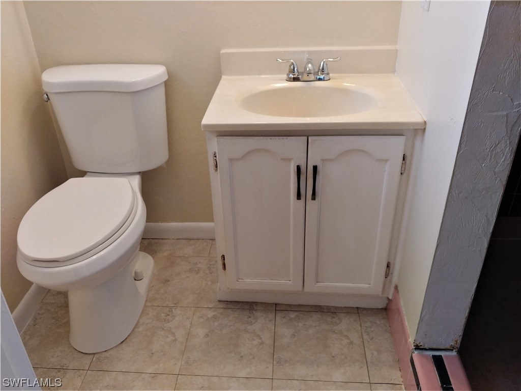 112 Clayton Avenue Lehigh Acres, FL 33936 - Photo 12 of 16 a bathroom with a toilet sink and mirror