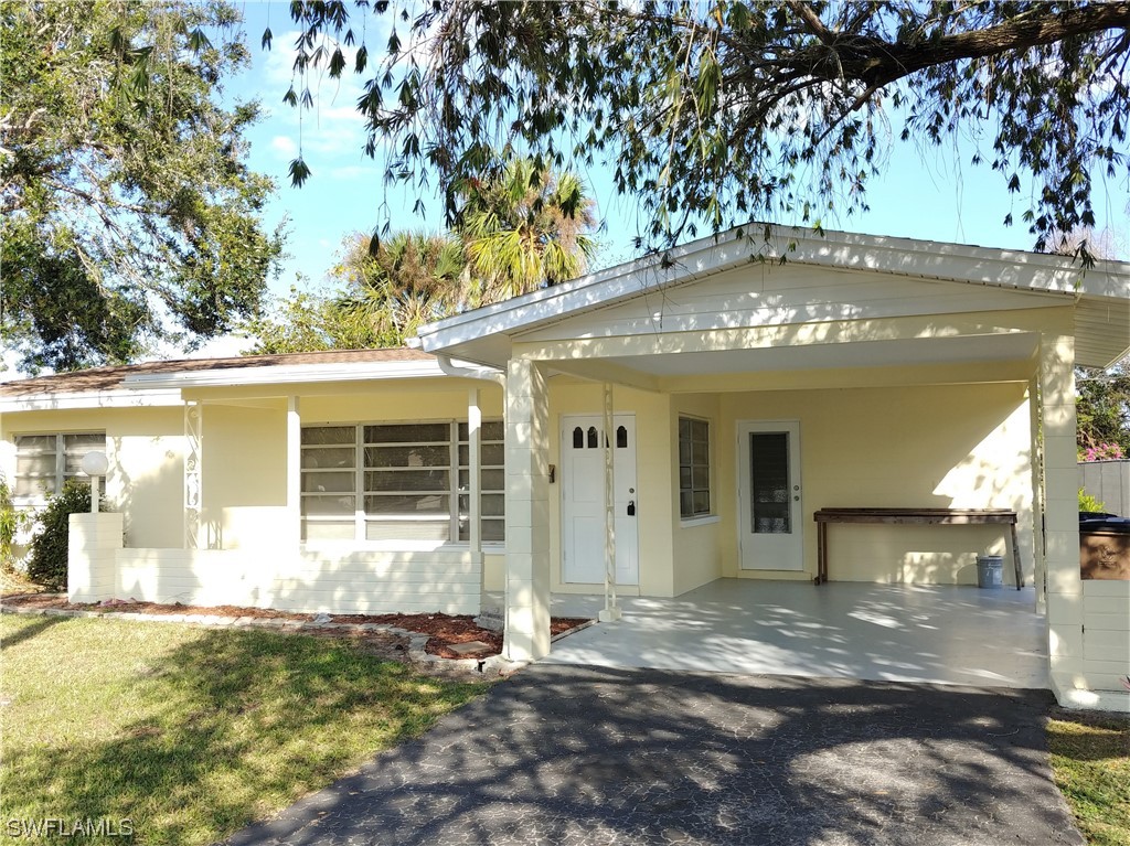 112 Clayton Avenue Lehigh Acres, FL 33936 - Photo 15 of 16 a view of a house with a yard