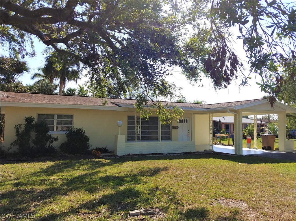 112 Clayton Avenue Lehigh Acres, FL 33936 - Photo 16 of 16 front view of a house with a yard