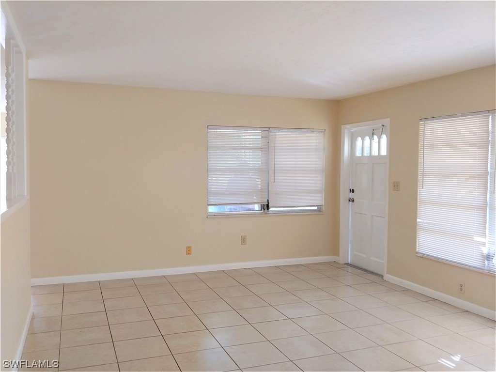 112 Clayton Avenue Lehigh Acres, FL 33936 - Photo 5 of 16 a view of an empty room with a window
