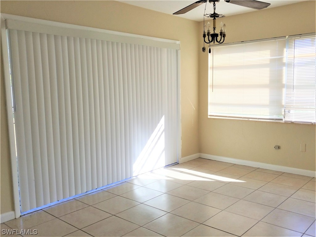 112 Clayton Avenue Lehigh Acres, FL 33936 - Photo 8 of 16 a view of an empty room with a window