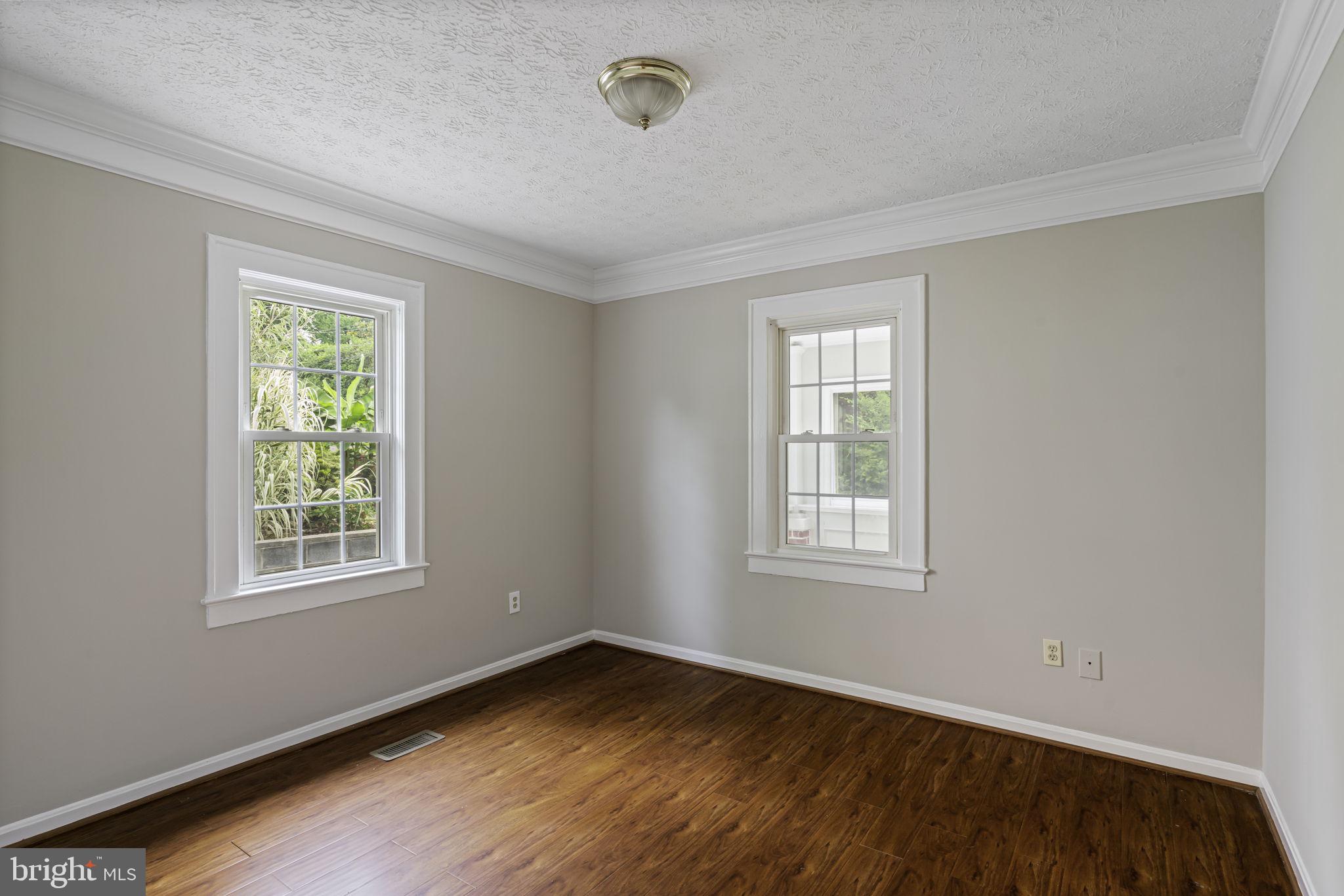 19316 Weaver Road Triangle, VA 22172 - Photo 21 of 33 a view of an empty room with wooden floor and a window