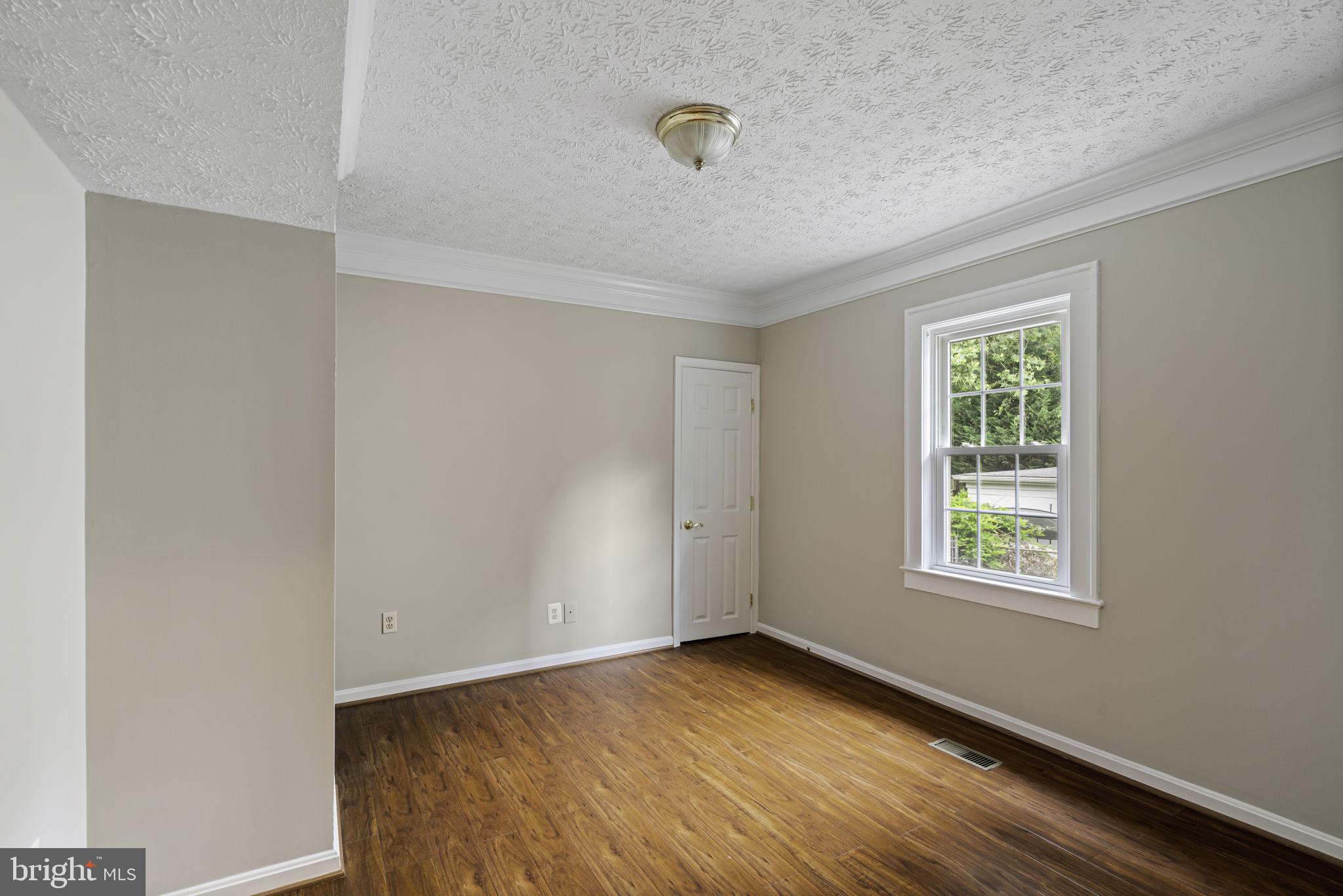 19316 Weaver Road Triangle, VA 22172 - Photo 23 of 33 a view of an empty room with wooden floor and a window