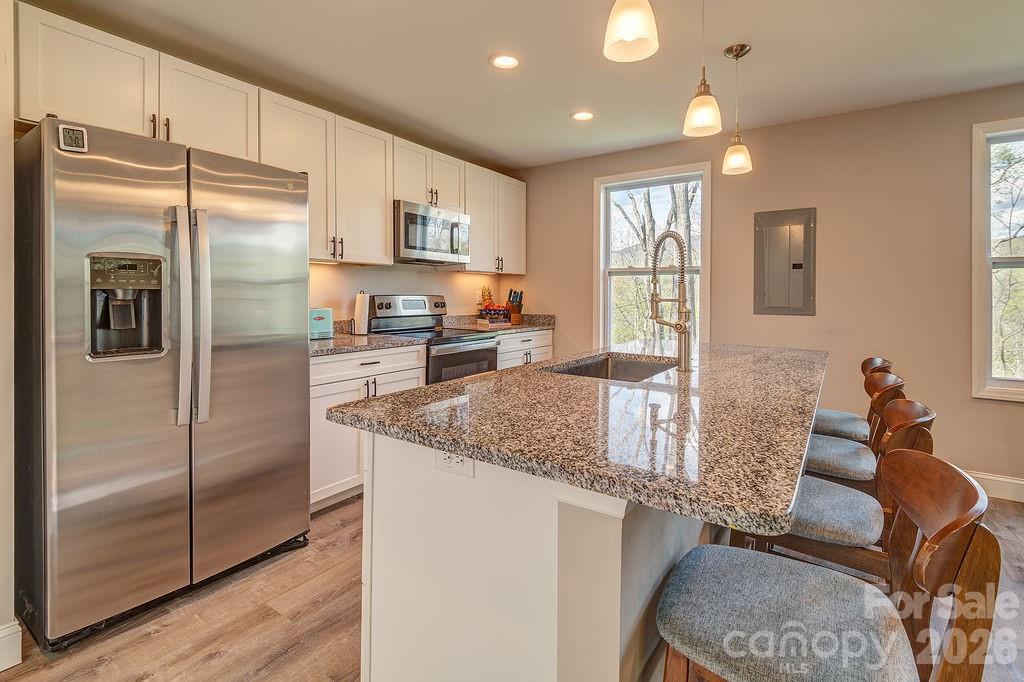 343 Garren Creek Road Fairview, NC 28730 - Photo 15 of 30 a kitchen with stainless steel appliances granite countertop a refrigerator a sink and a stove