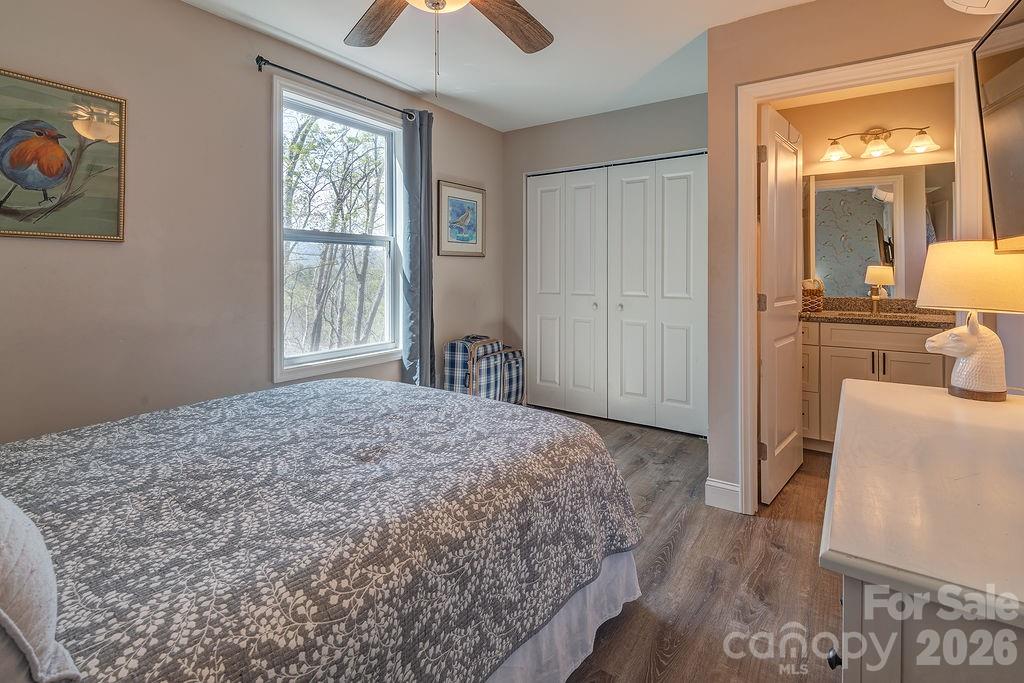 343 Garren Creek Road Fairview, NC 28730 - Photo 23 of 30 a bedroom with a bed and a window