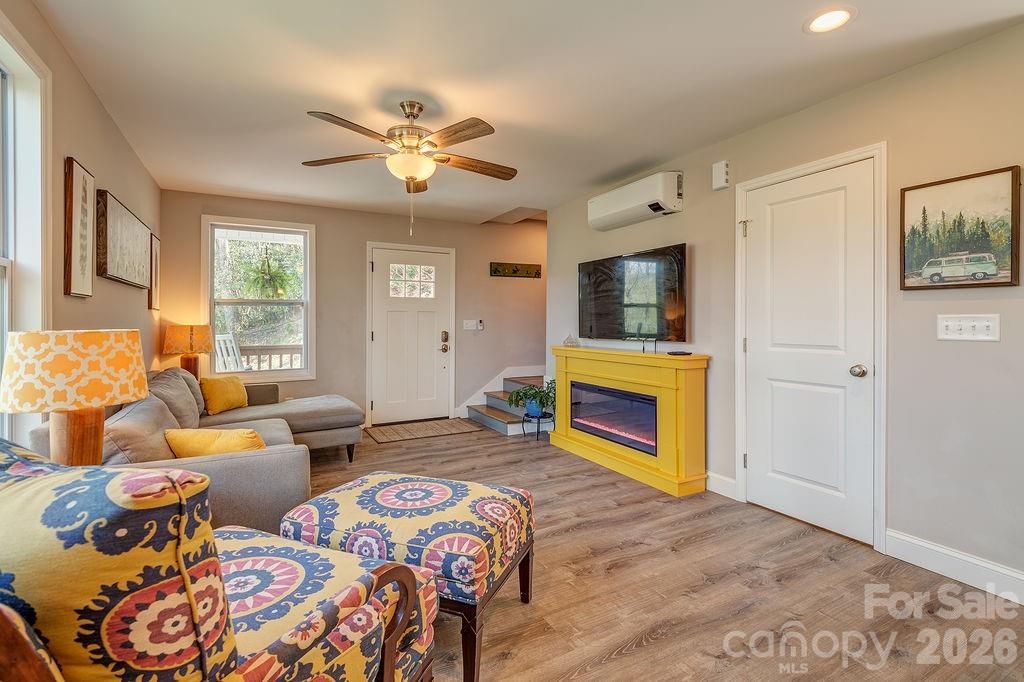 343 Garren Creek Road Fairview, NC 28730 - Photo 5 of 30 a bedroom with furniture and a fireplace