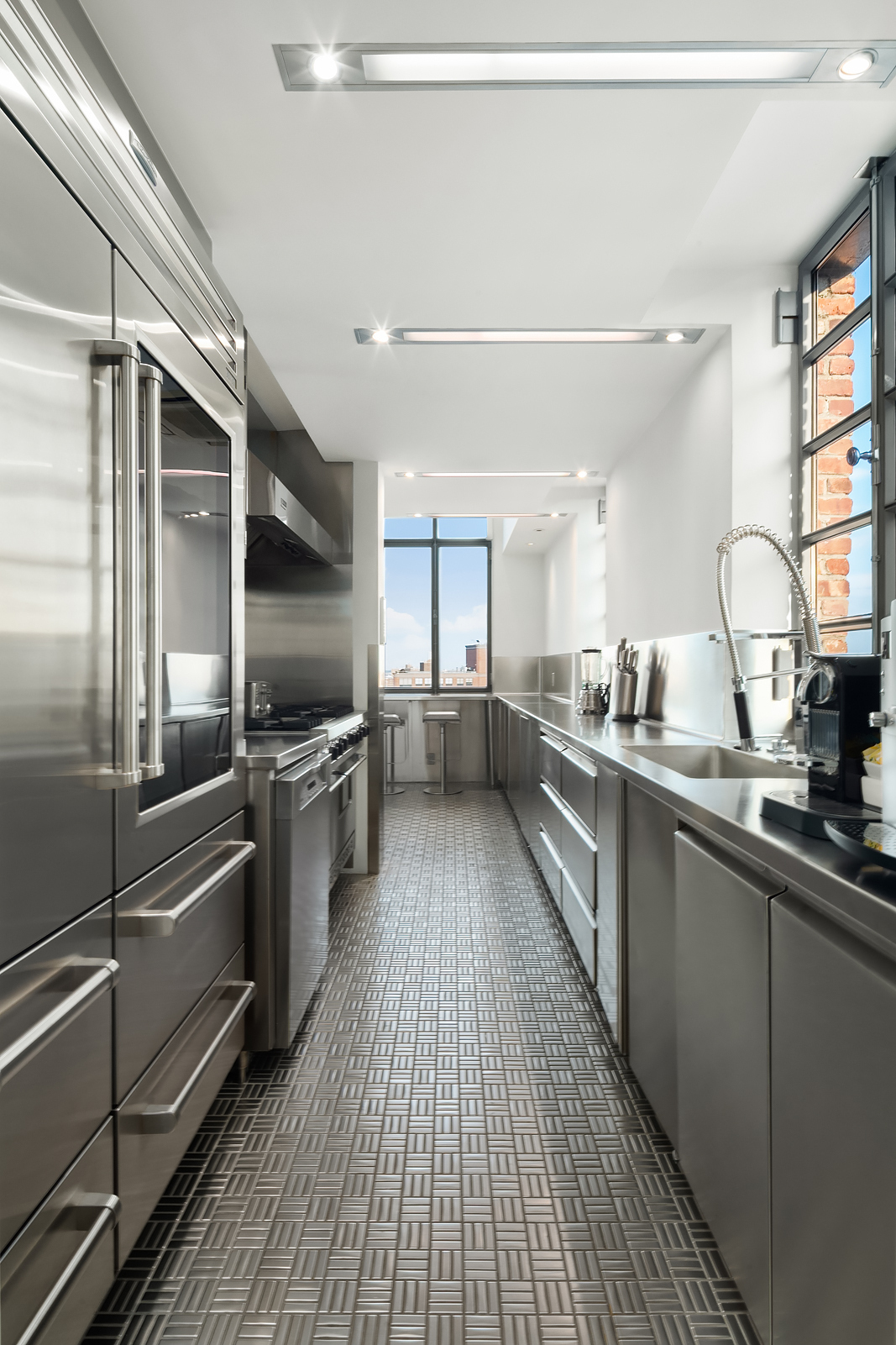 704 Broadway, Unit PH Manhattan, NY 10003 - Photo 15 of 30 a large kitchen with stainless steel appliances lots of counter space and a sink