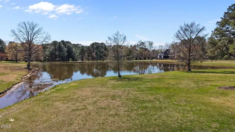a view of a lake with houses in the back