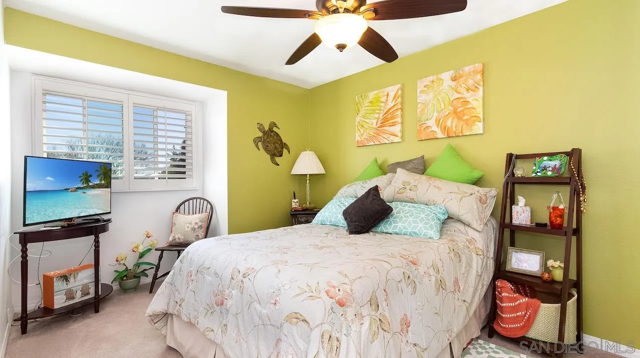 14140 Carmel Ridge Road San Diego, CA 92128 - Photo 12 of 17 a bedroom with a bed and a chandelier