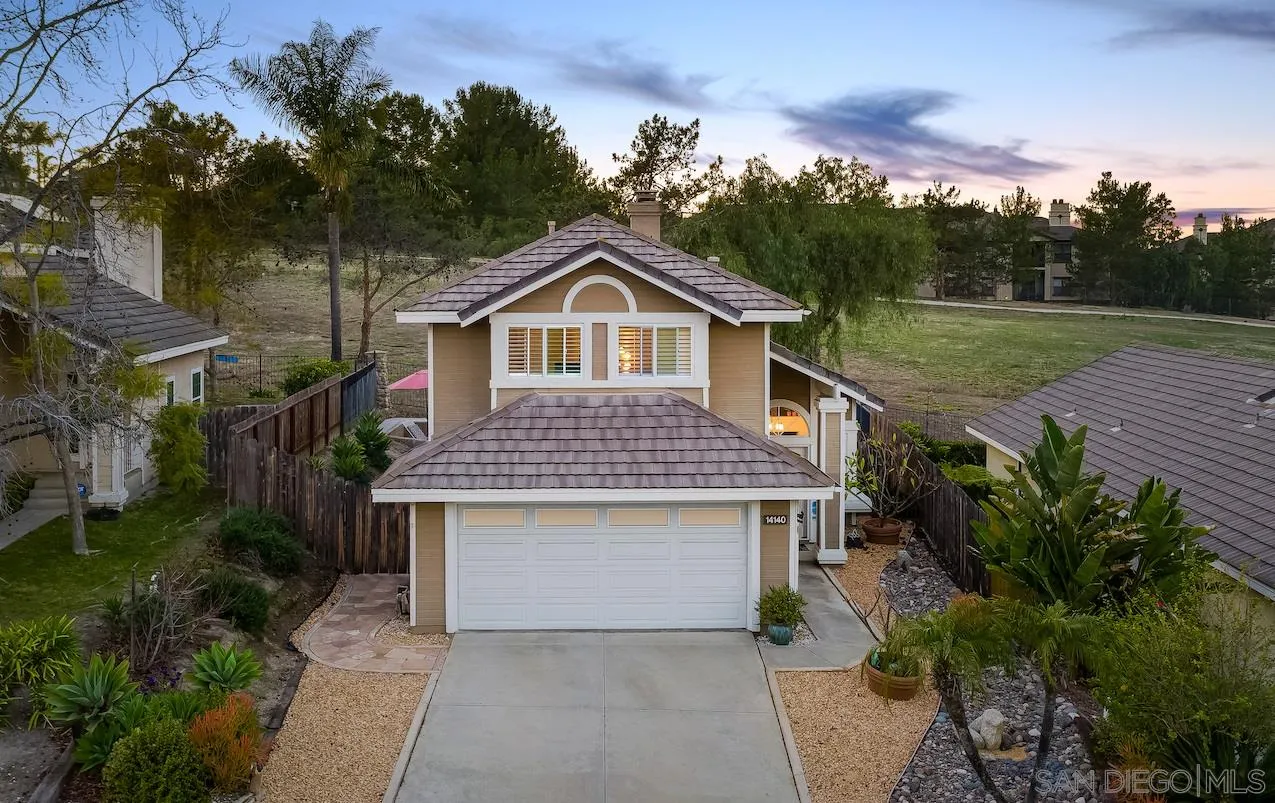 14140 Carmel Ridge Road San Diego, CA 92128 - Photo 2 of 17 a front view of a house with a garden