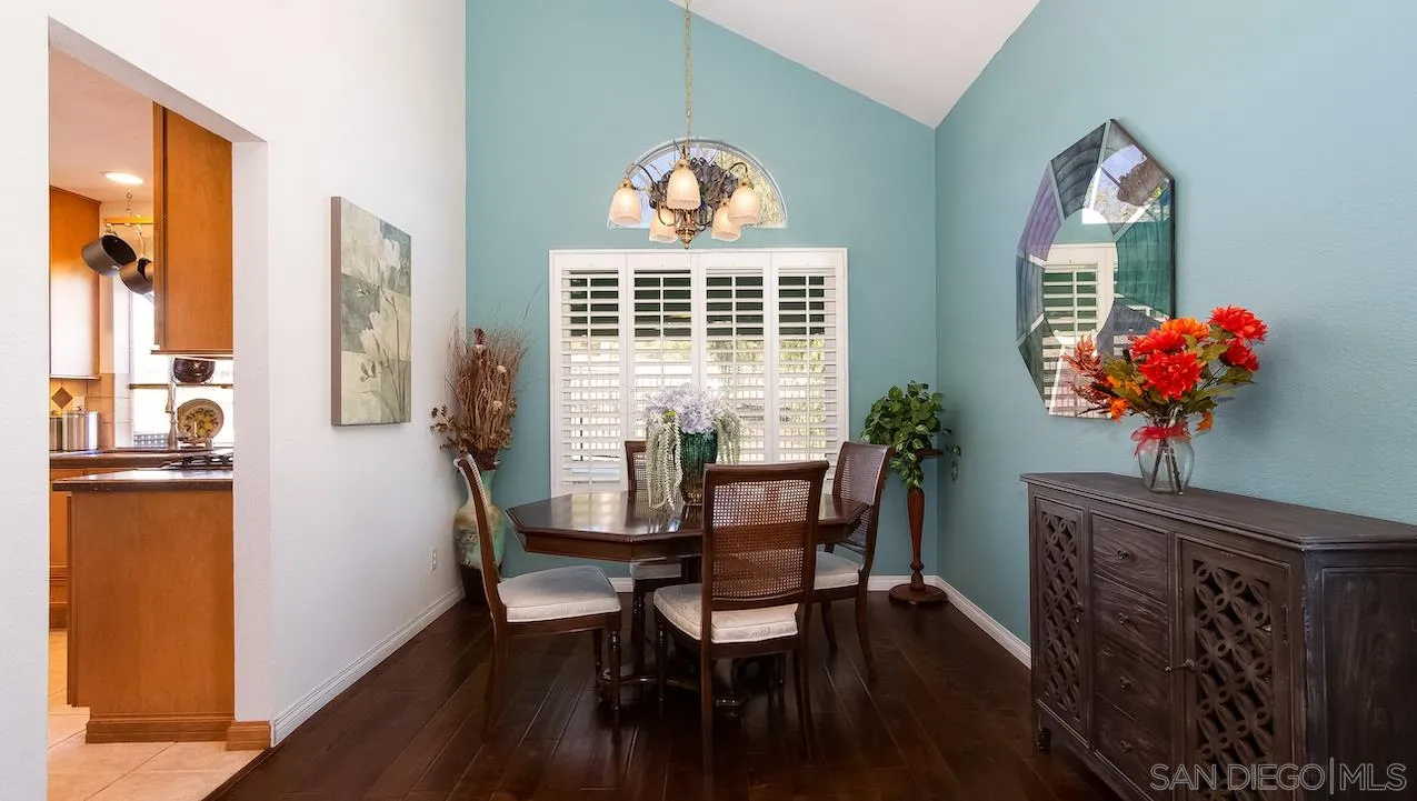 14140 Carmel Ridge Road San Diego, CA 92128 - Photo 3 of 17 a dining room with furniture potted plants and wooden floor