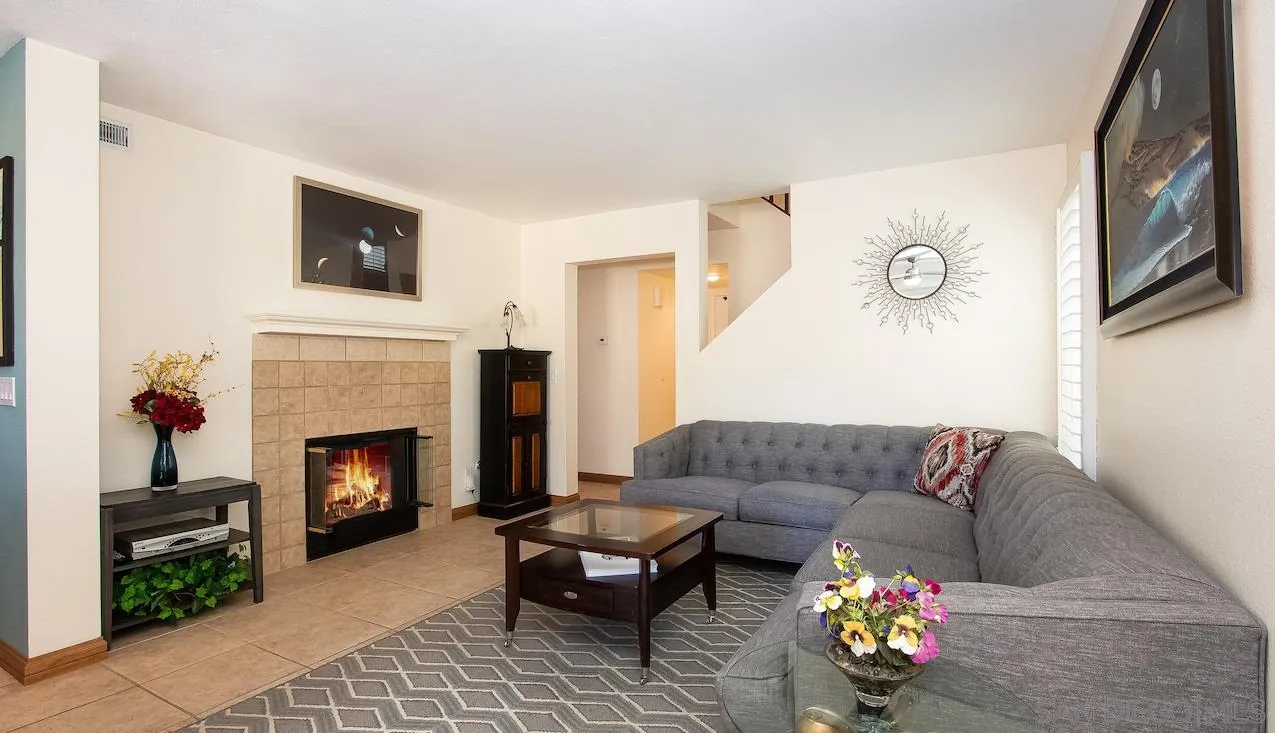14140 Carmel Ridge Road San Diego, CA 92128 - Photo 5 of 17 a living room with furniture and a fireplace